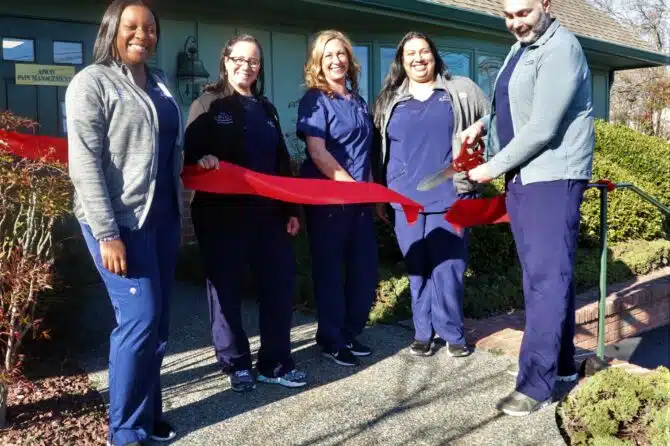 Photo of Dr. Abdallah cutting the ribbon at the grand opening of his new Lewes DE office